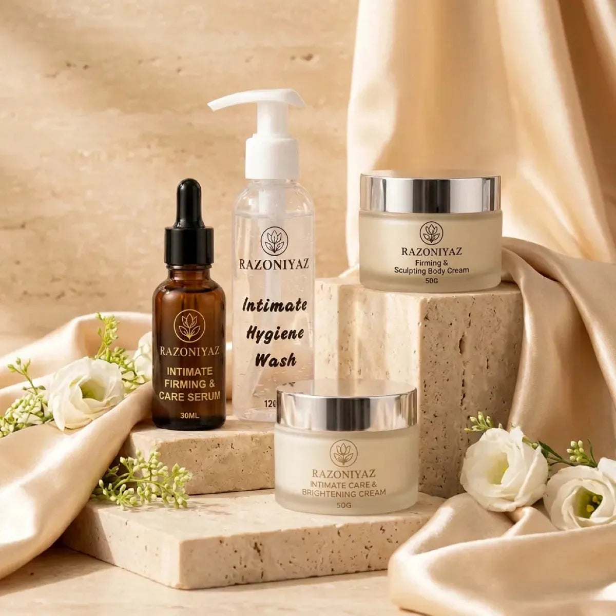 stone steps aur satin wali: Razo Niyaz wash, serum, body cream and brightening cream on stone steps with champagne satin and white flowers.